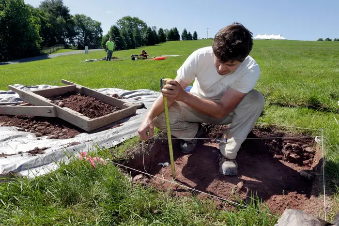 Paul Brown, of the Public Archaeology Facility at Binghamton University, measures a dig at the site of the original Woodstock Music and Art Fair, in Bethel, N.Y. The main mission of Binghamton University's Public Archaeology Facility is to help map out more exactly where The Who, Creedence Clearwater Revival, Janis Joplin and Joe Cocker wowed the crowds 49 years ago (Richard Drew/AP/REX/Shutterstock)